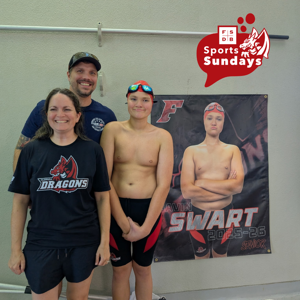 Gavin and his family are smiling for a photo next to Gavin's senior poster inside the pool facility. 