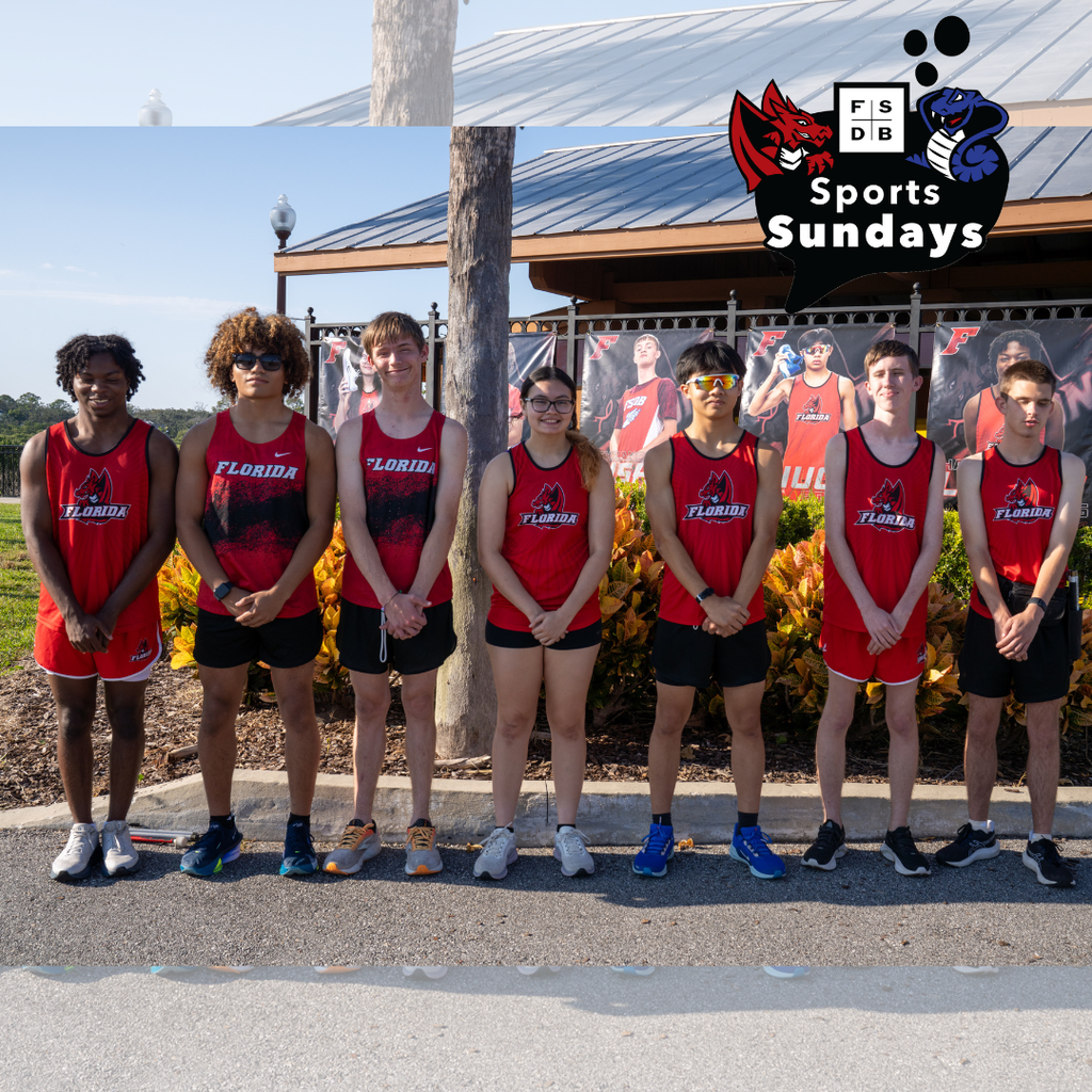 Seven Senior Cross Country runners wear FSDB red uniform smile for a photo as a group in front of their senior posters outside. 