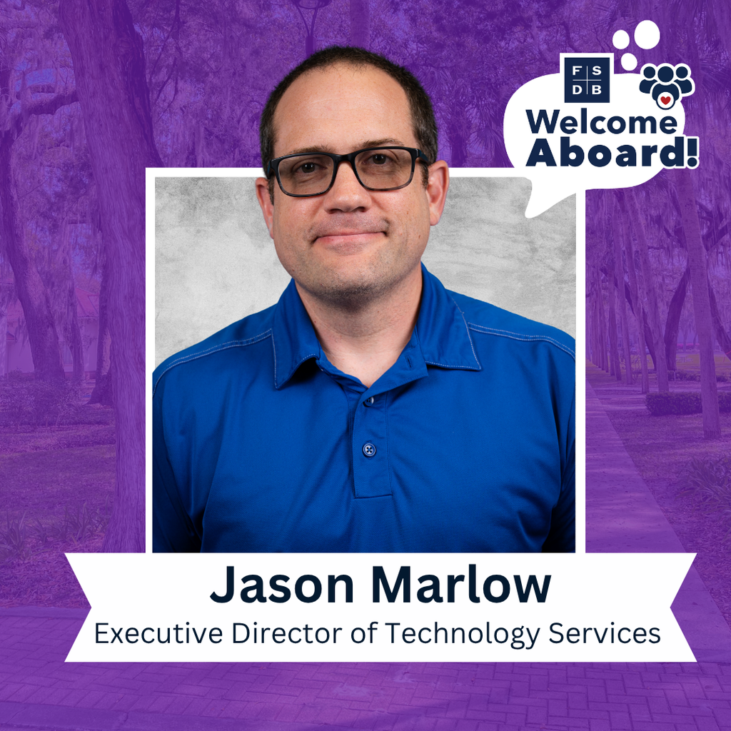 Jason is wearing a blue collar shirt smiling for his photo with a silver backdrop and purple background. Below the photo is a white textbox that says "Jason Marlow, Executive Director of Technology Services"