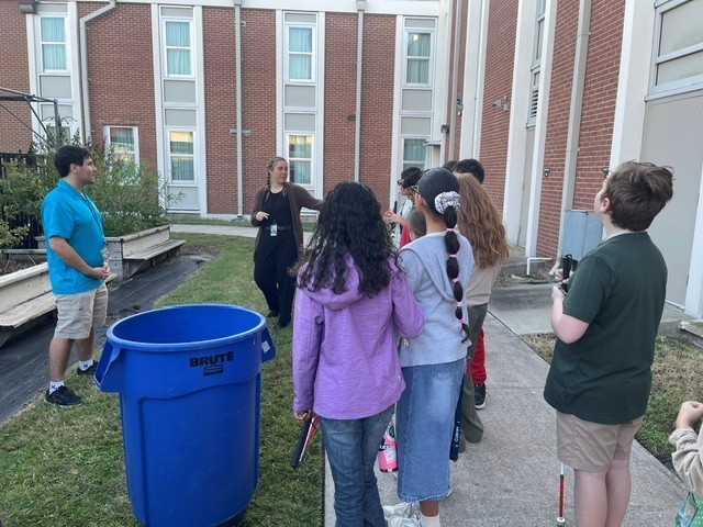 Students listen to Garden Center staff discuss plants