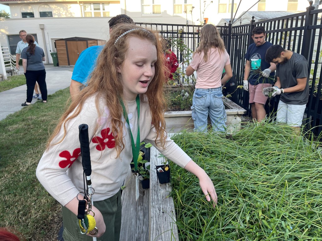 Maely touching some grassy plants
