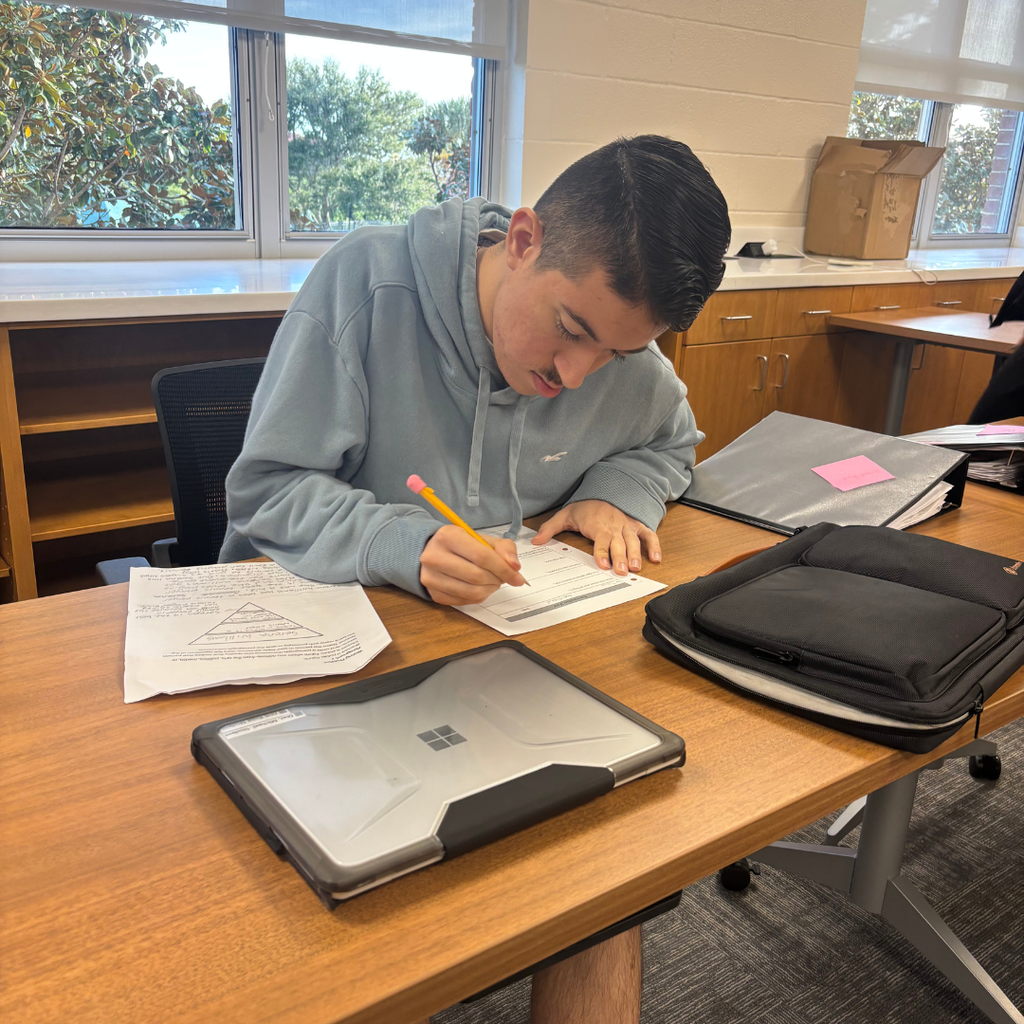 Tyler giving the teacher feedback on her paragraph in the classroom. 