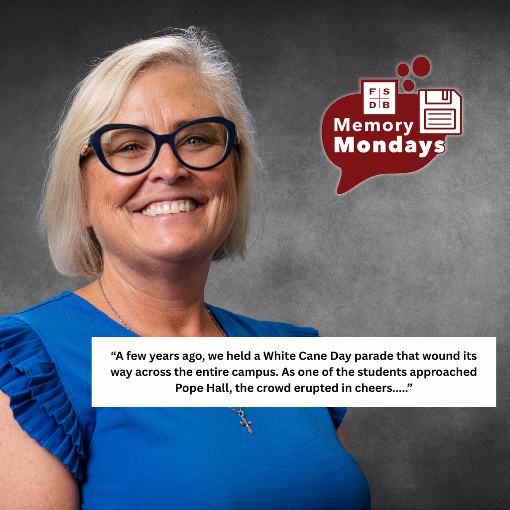 Jenny is wearing a blue shirt smiling for her photo with a black background. Below is a white text box with a quote that says A few years ago, we held a White Cane Day parade that wound its way across the entire campus. As one of the students approached Pope Hall, the crowd erupted in cheers..."
