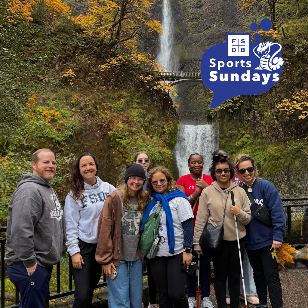 Girls Goalball team smile for a photo together outside in Multnomah Falls in Oregon. 