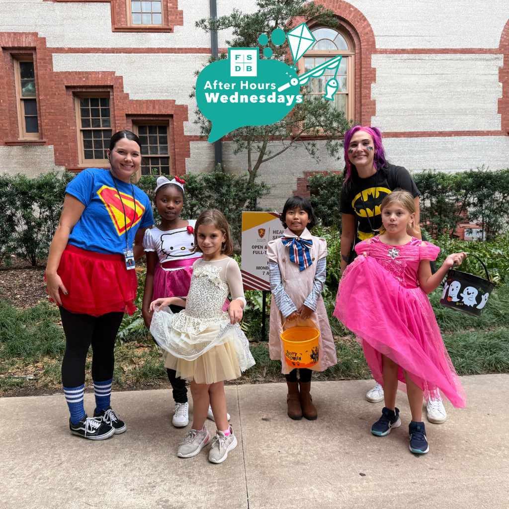 Group of dorm staff dressed up for Halloween along with the students smiling for a photo outside of Flagler College,.