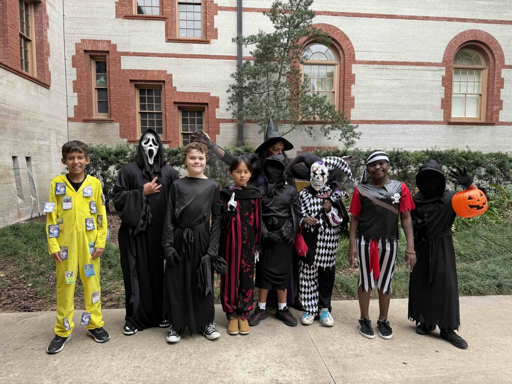 Group of dorm staff dressed up for Halloween along with the students smiling for a photo outside of Flagler College,.