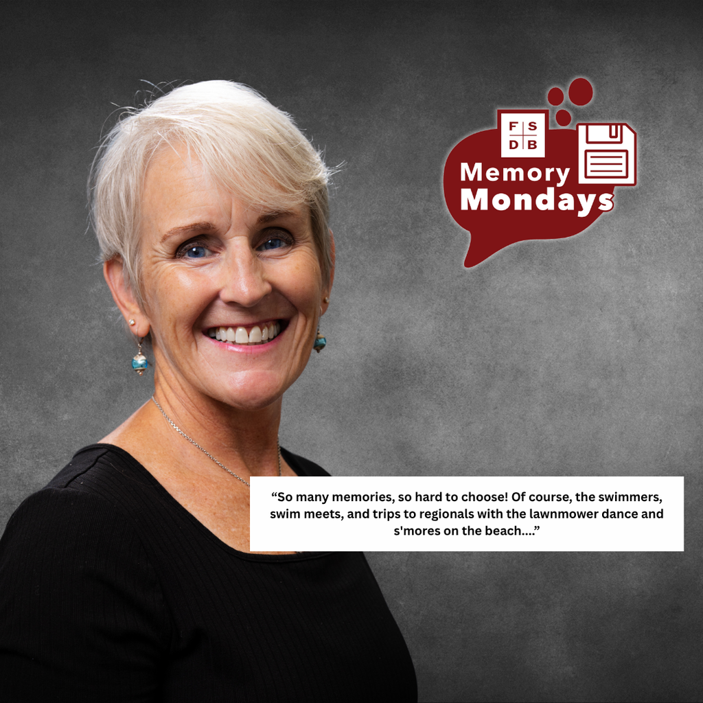 Susan is wearing a black short sleeve shirt smiling for her photo with a gray background. On the right side of her is a white text box that shares a quote of "So many memories, so heard to choose! Of course, the swimmers, the swim meets, and trips to regionals with the lawnmower dance and s'mores on the beach..."