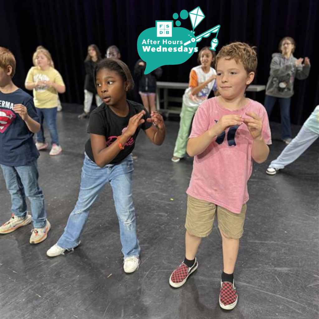 Two students dancing on stage in Kirk.