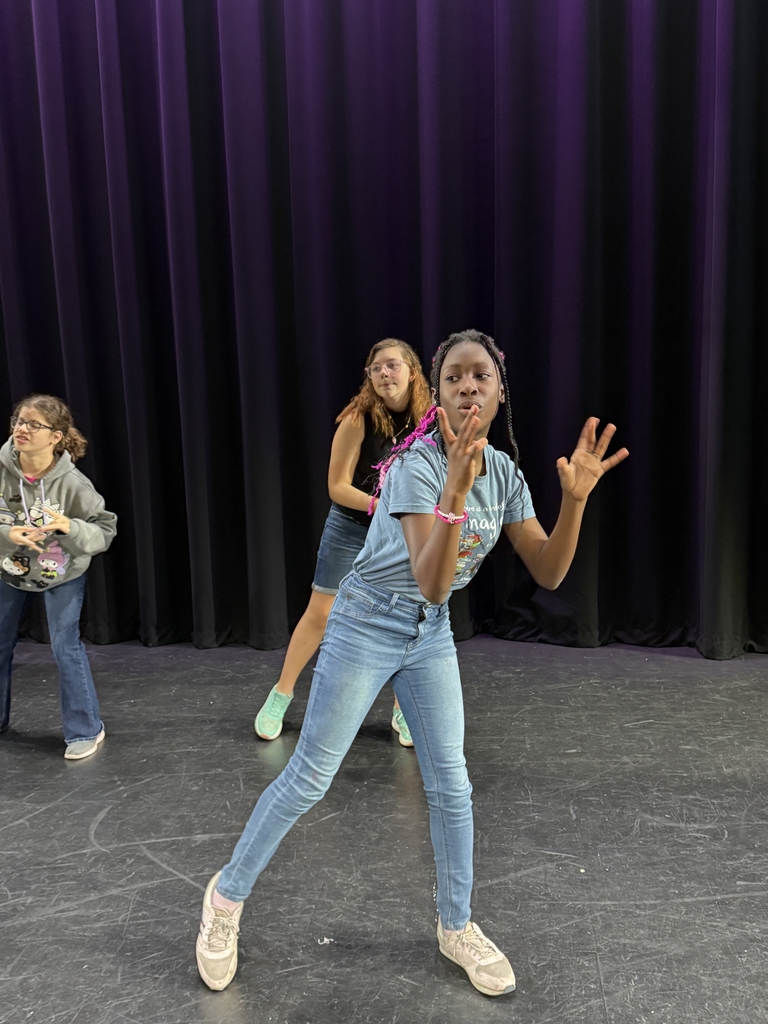 Students dancing on stage in Kirk.
