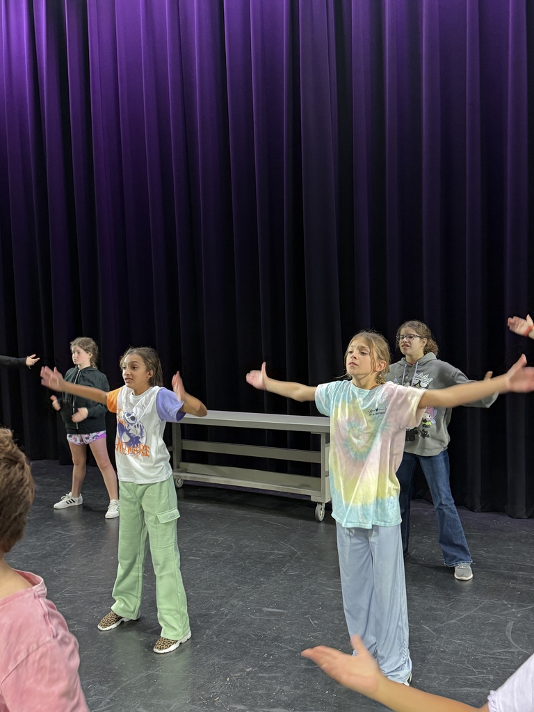 Students dancing on stage in Kirk.