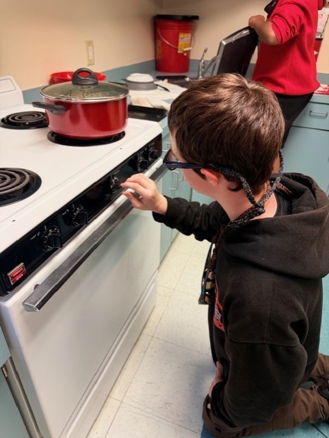 Aubrey opening up the oven to check on the Cookes. 