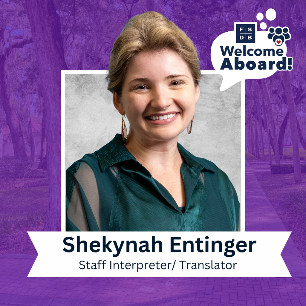 Shekynah is wearing a dark green colored shirt smiling for her photo with a silver backdrop and purple background. Below her photo says "Shekynah Entinger, Staff Interpreter/Translator".