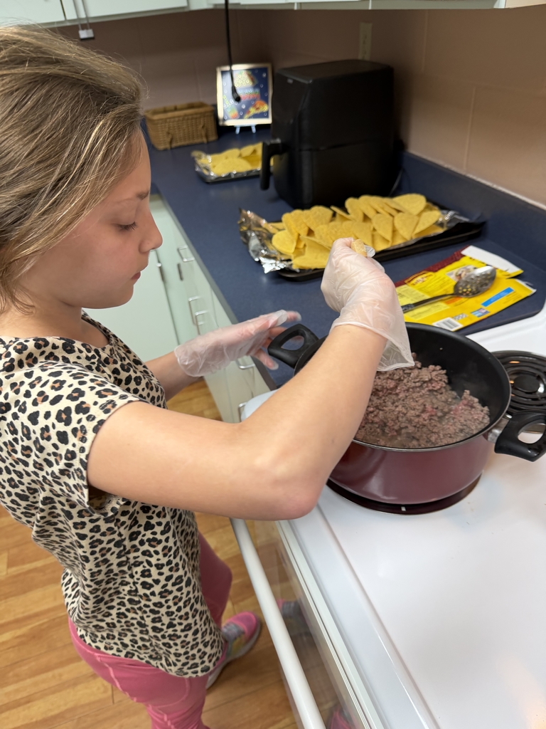 A student is working on browning the beef inside the Cary White kitchen . 