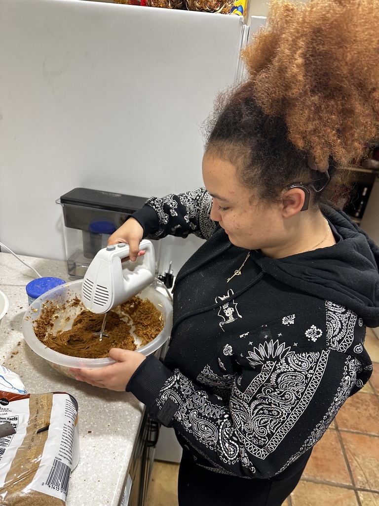 A student is working on making the pumpkin pie inside the apartment kitchen.