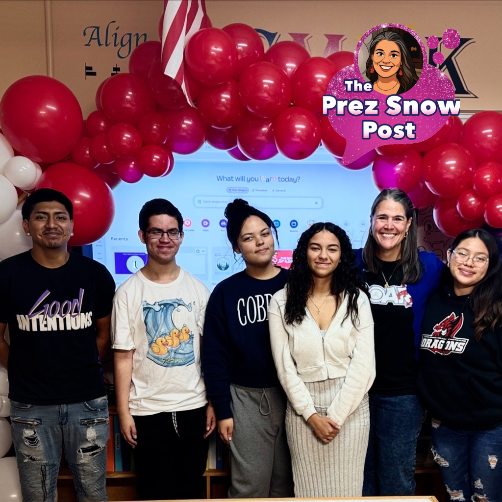A group of DB Designs students smile with President Snow inside the DB Design classroom. 