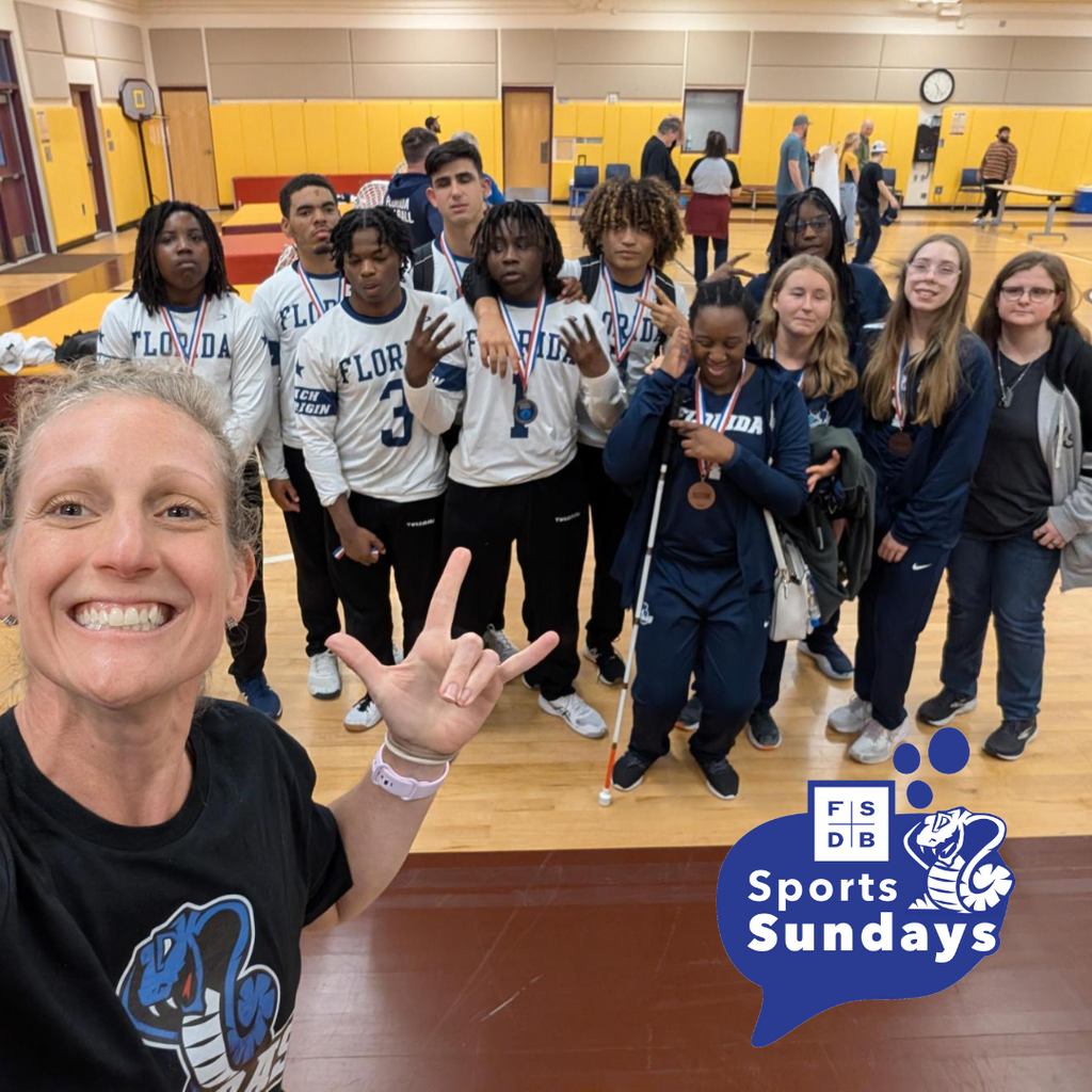 FSDB Athletic Director take a selfie with the boys and girls goal ball teams inside the gym.