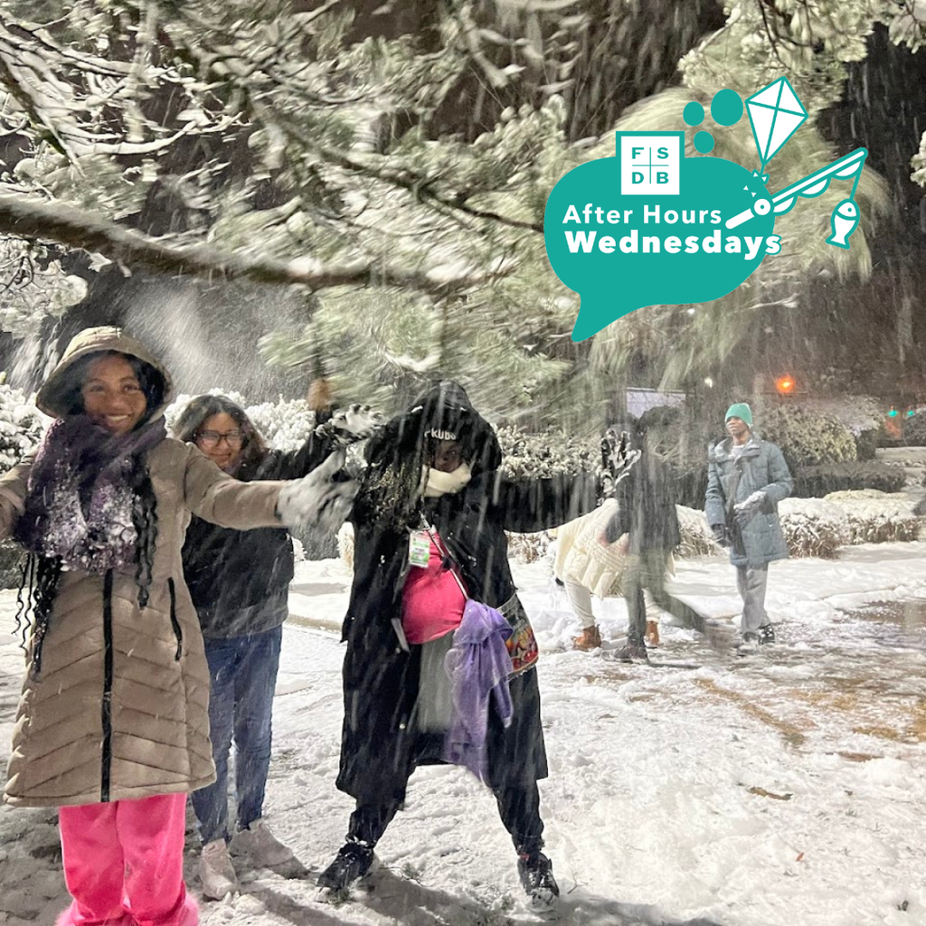 Students bundled up in winter hats, scarfs and gloves smile and play in the snow in Washington D.C.