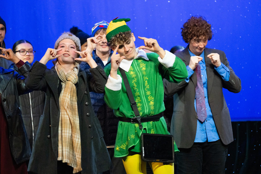 Two characters Buddy the Elf and Jovie rom the show sign on stage in Kirk.
