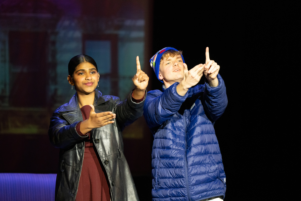 Buddy the Elf's step mom and brother sign on stage in Kirk.