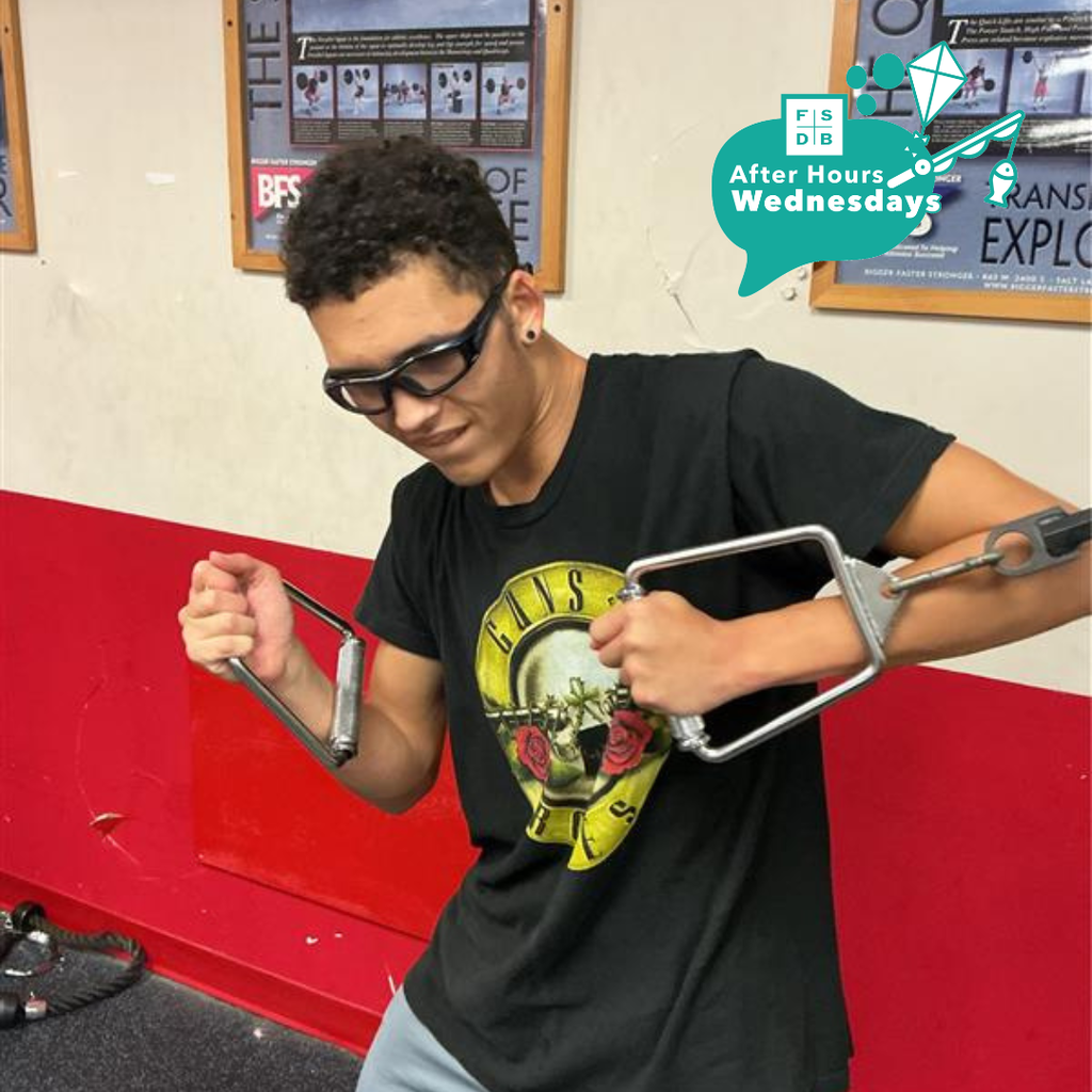 A student working out in the weight room. 