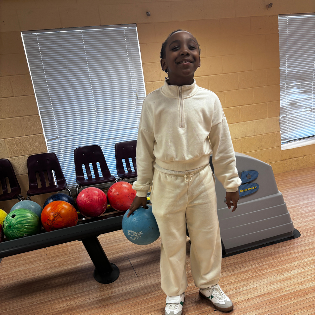 A student is enjoying herself at the bowling alley on campus.