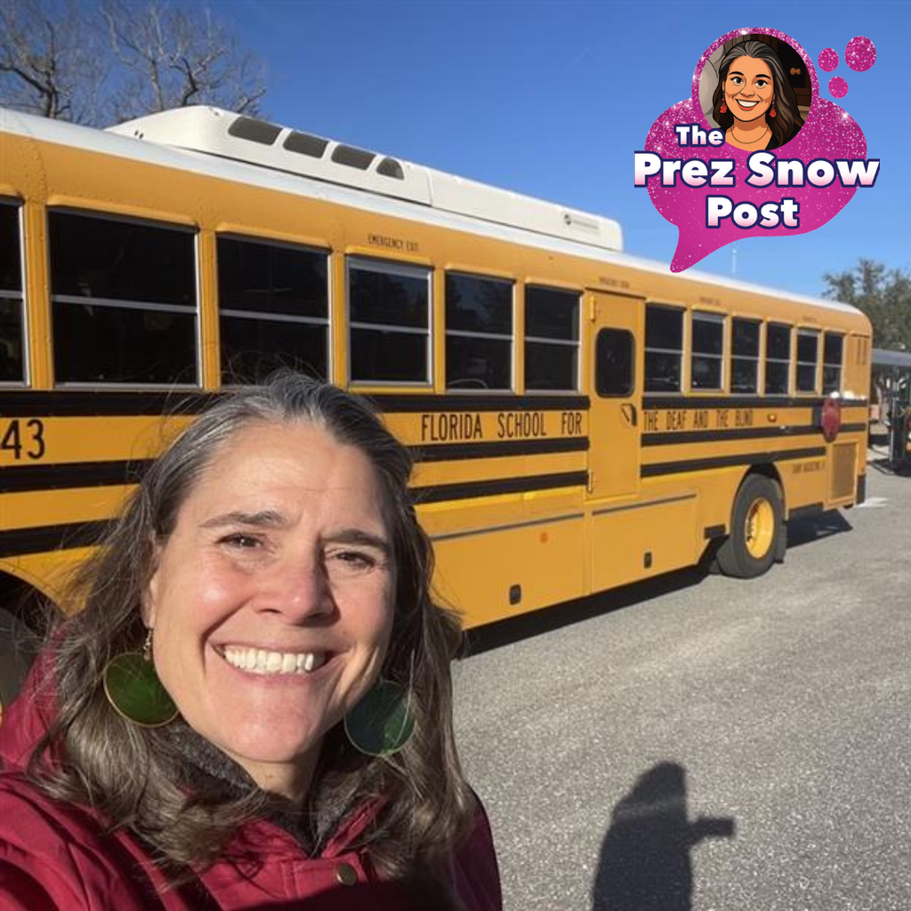 A selfie of Tracie Snow smiling with the FSDB yellow bus. 