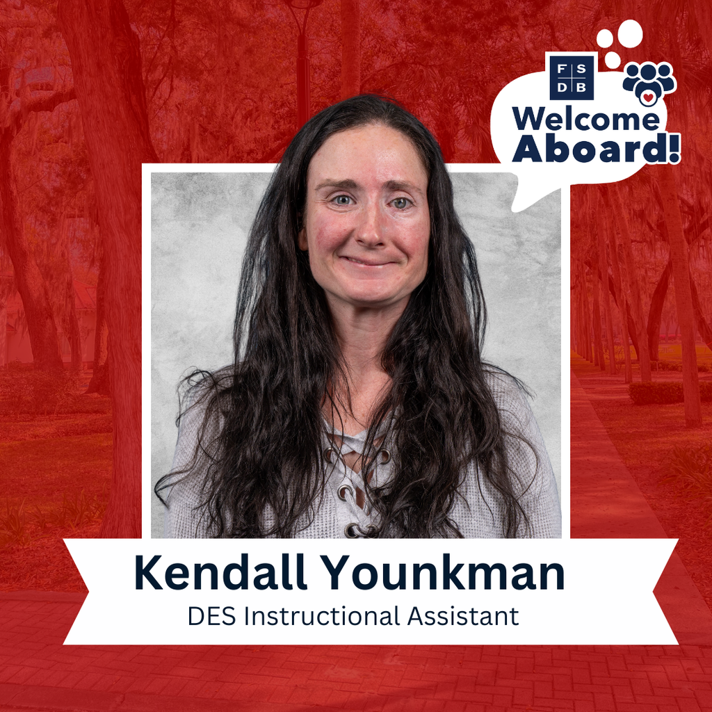 Kendall is wearing a gray long sleeve shirt smiling for her photo with a silver backdrop, with a white text box below that says "Kendall Younkman, DES Instructional Assistant"