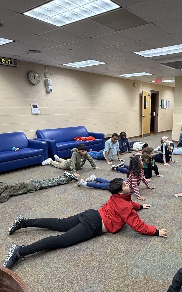Blind students doing yoga in the hallway of Cary White. 