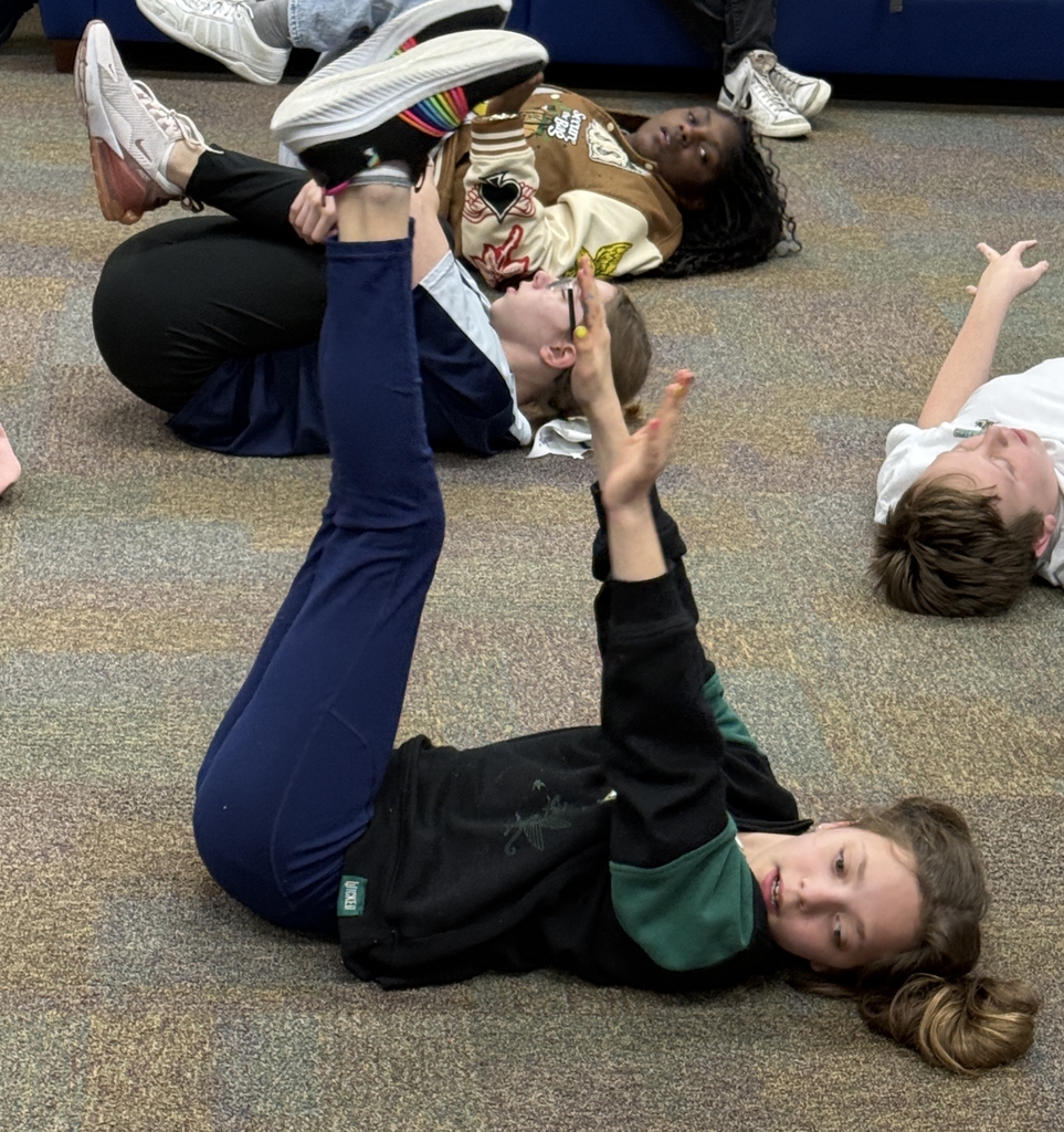 Blind students doing yoga in the hallway of Cary White. 
