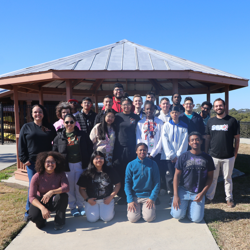 Group of FSDB SOAR students smiling for a photo together outside by the FSDB pavilion by the water.