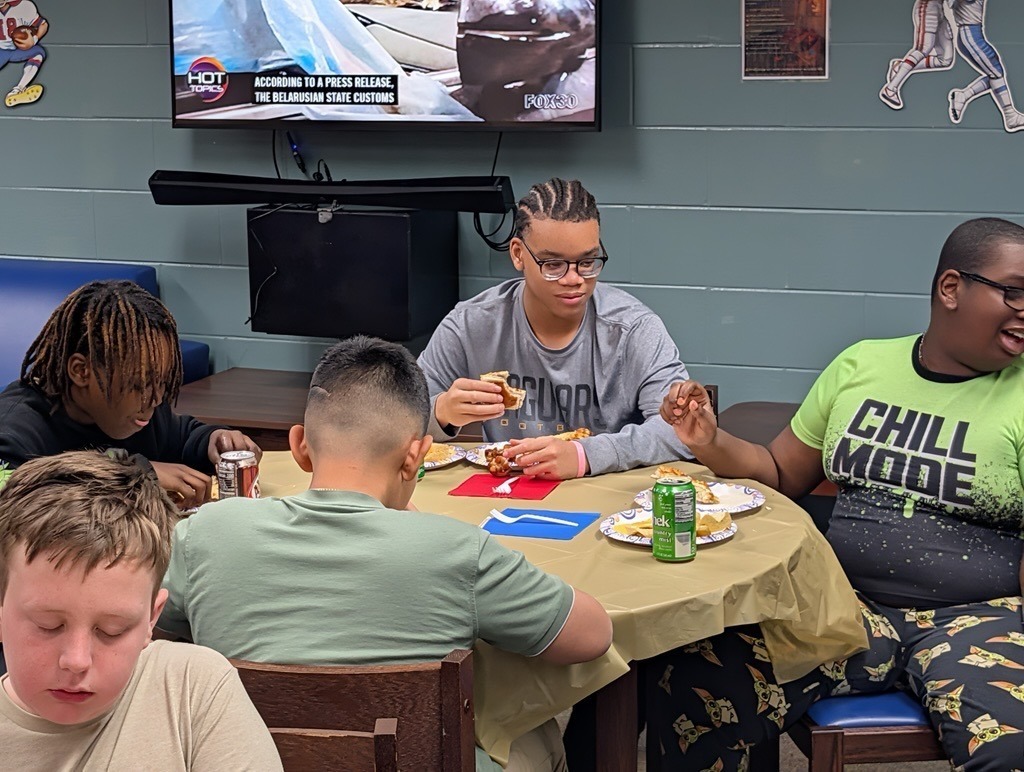 Blind students eat while watching the Super Bowl.