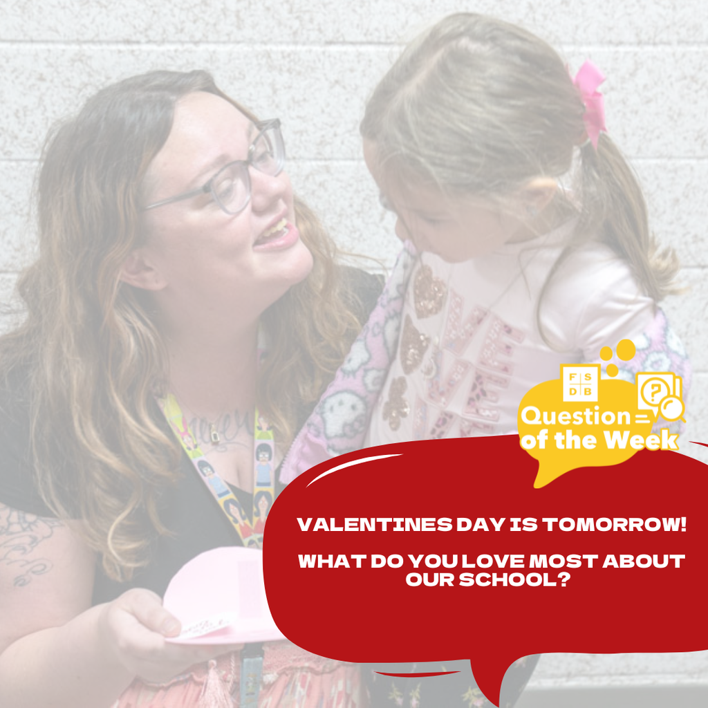 Faded photo of a staff member and mom to a previously ELC student handing her a valentines day heart card inside the hallway in Moore Hall. On the bottom left is a red quote box that says "Valentines Day is tomorrow! What do you love most about our school?"