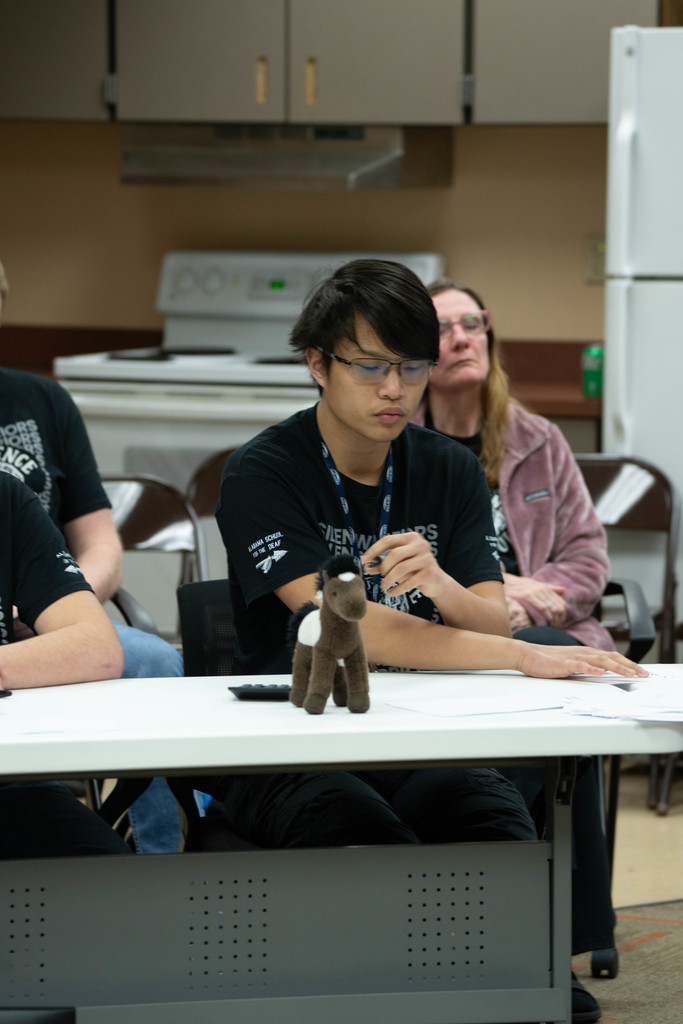 A student thinks of his answer before writing it down on a paper inside a classroom.