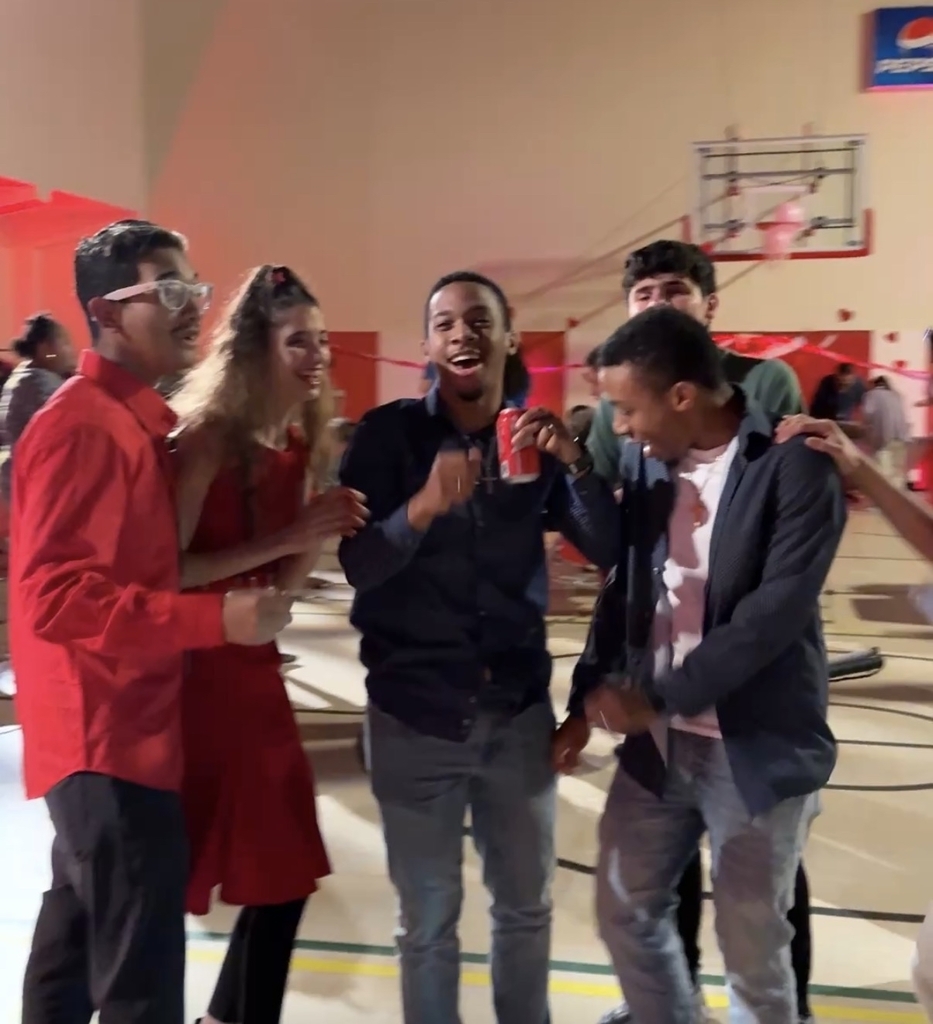 Group of students of students dancing together inside the gym.