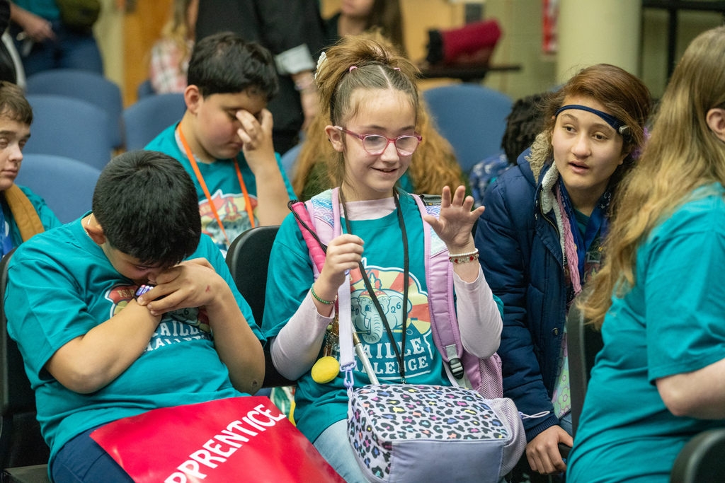 Students participating in the Braille Challenge are sitting inside the music building excitedly waiting for the challenge to start. 