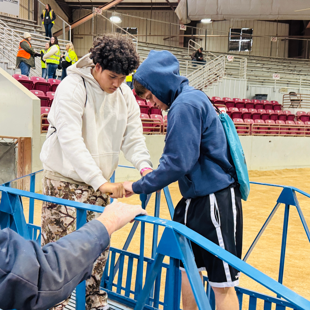 Two FSDB students standing on a blue structure inside the building. 