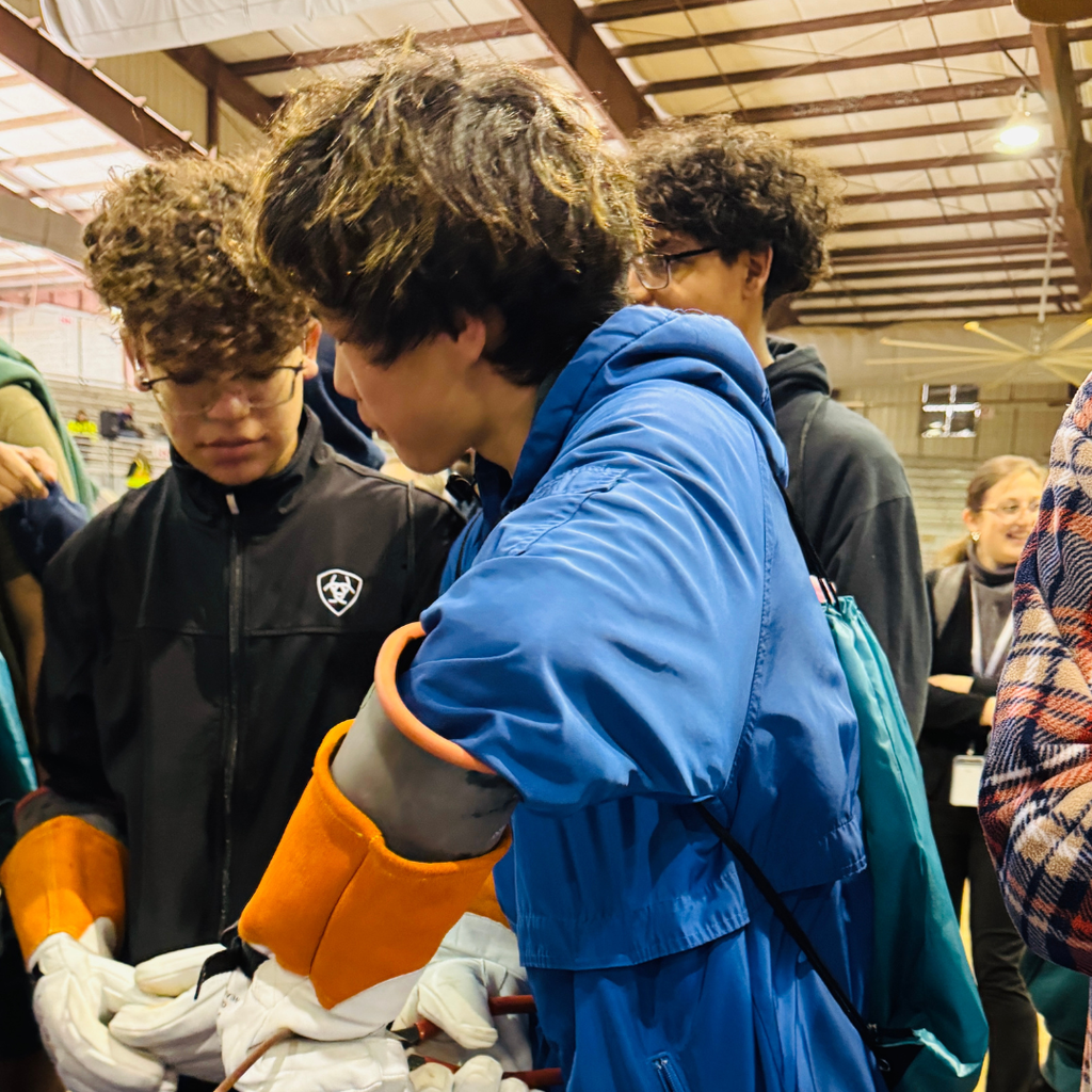 Closeup of a FSDB student wearing gloves and learning the new skill he was taught. 