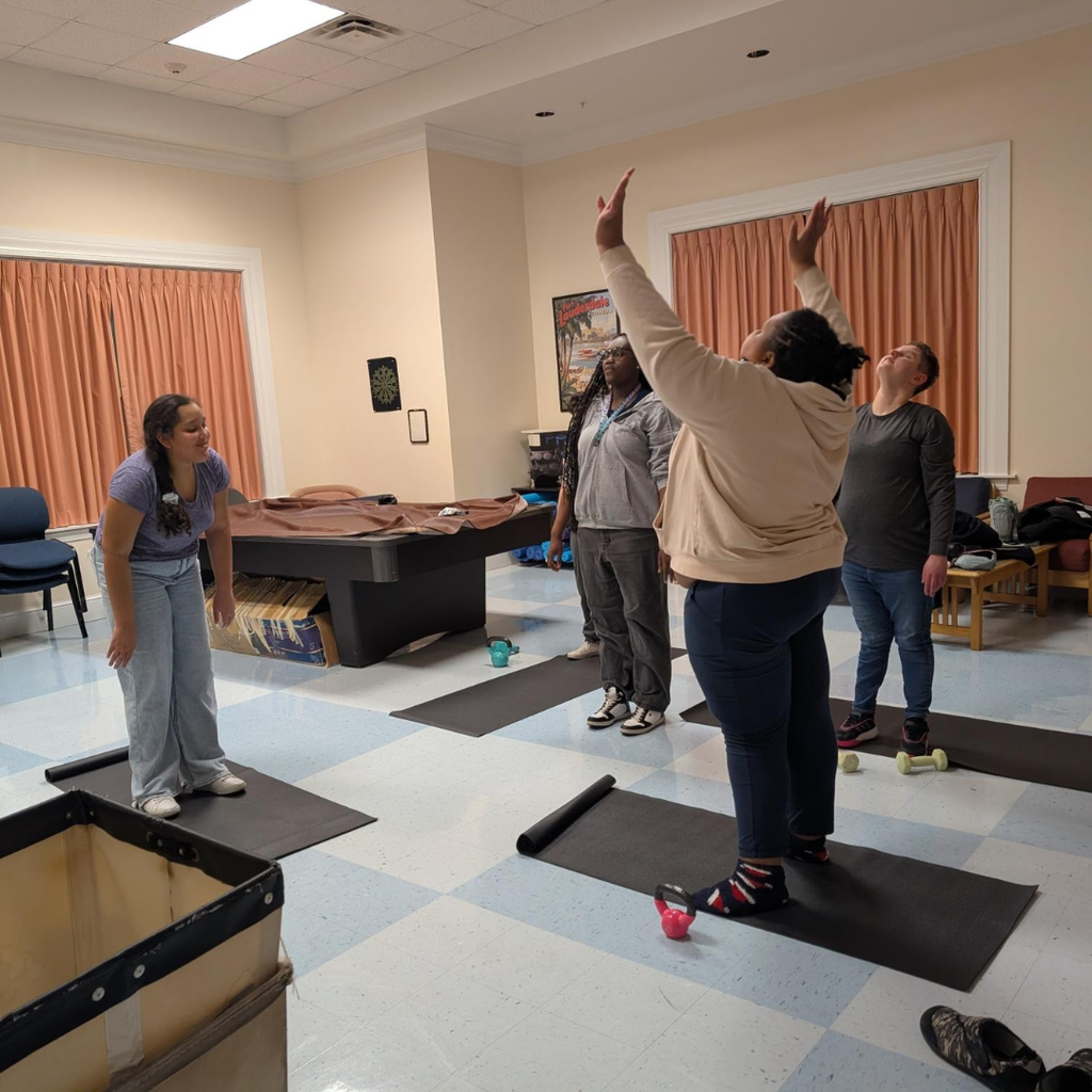 Group of girls are doing yoga inside the dorm. 