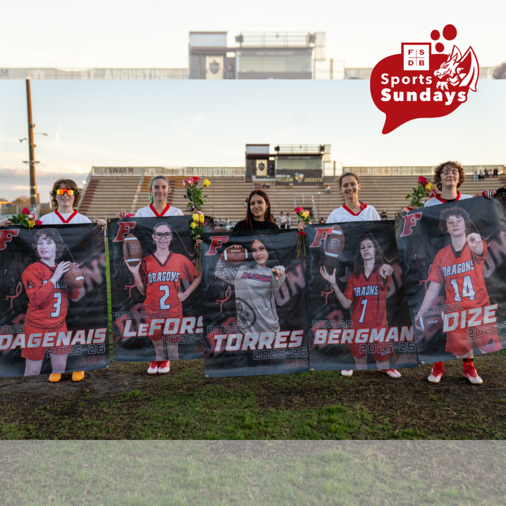 A photo of the five seniors holding their banners and flowers on the field of St. Augustine High School.