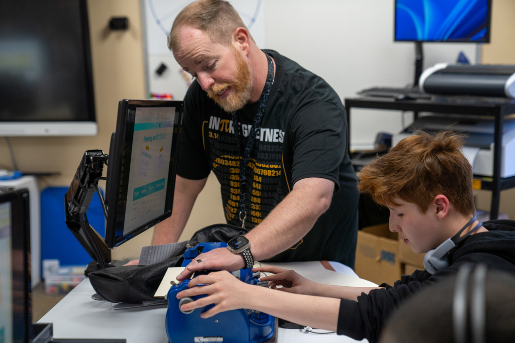 Mr. Keller checks a students answer inside his classroom. 