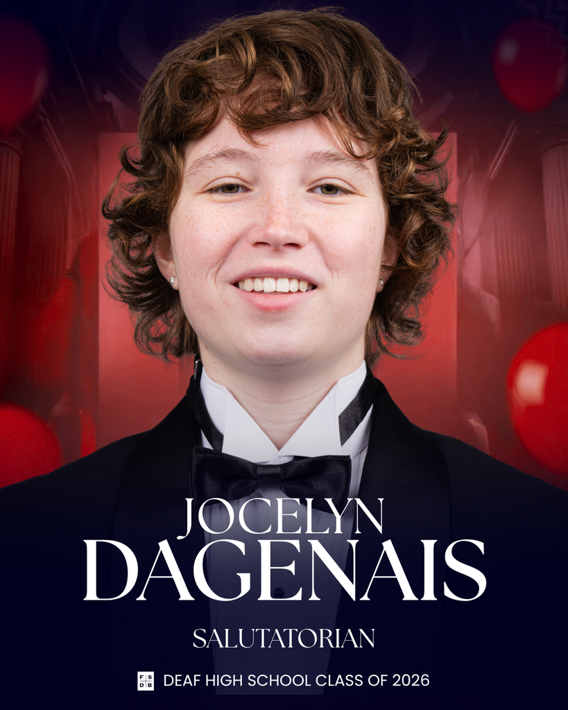Senior portrait of Jocelyn, wearing a tuxedo in front of a red background.