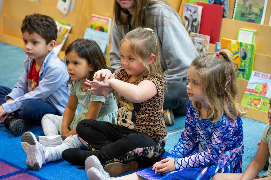ELC students sit and watch Dr. Renca present to the kids inside the classroom.