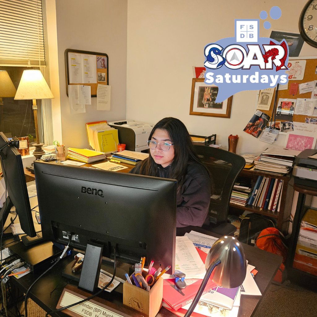 Andrea is sitting at BP office in the museum helping scanning and transferring photos into files.