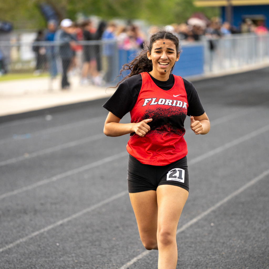 A FSDB girl runner focuses on running to the finish line. 