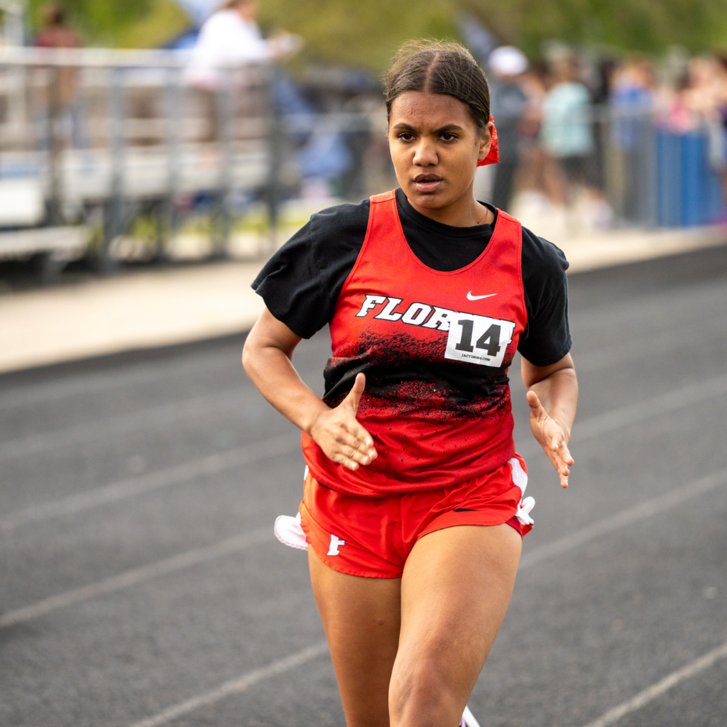 FSDB girl runner wears her uniform and focuses on running to the finish line. 