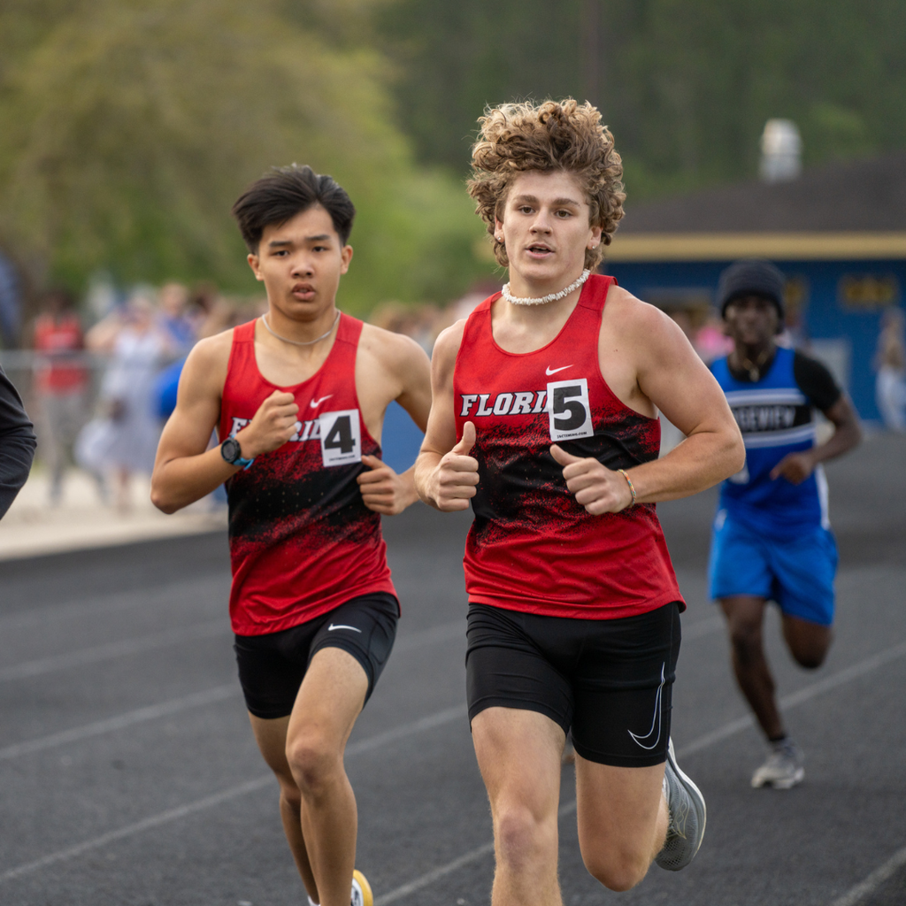 Two FSDB boy runners run to the finish line.