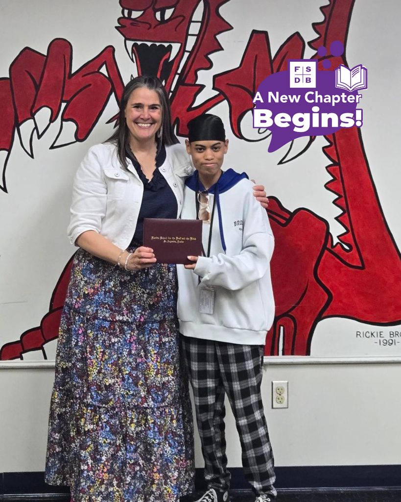 Sakura smiles with President Snow holding her diploma inside the Dragon's Lair. 