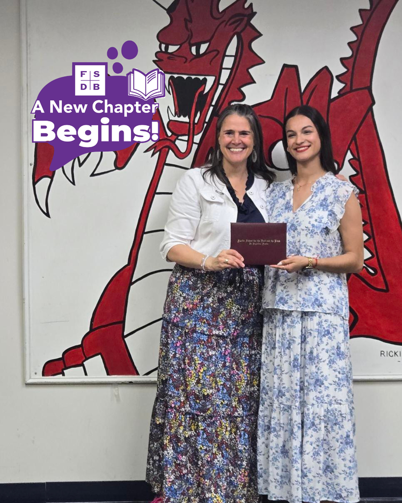Ariana smiles with President Snow holding her diploma inside the Dragon 's Lair. 
