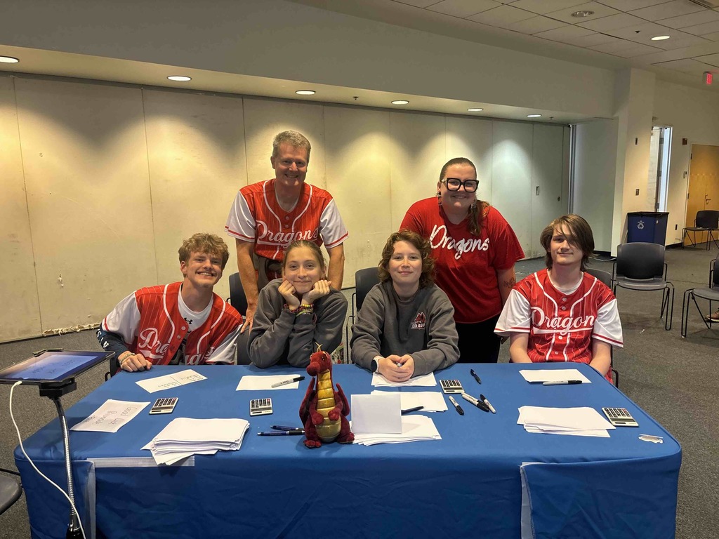 FSDB Academic Bowl team and staff smile for a photo together inside a classroom at Gallaudet University. 