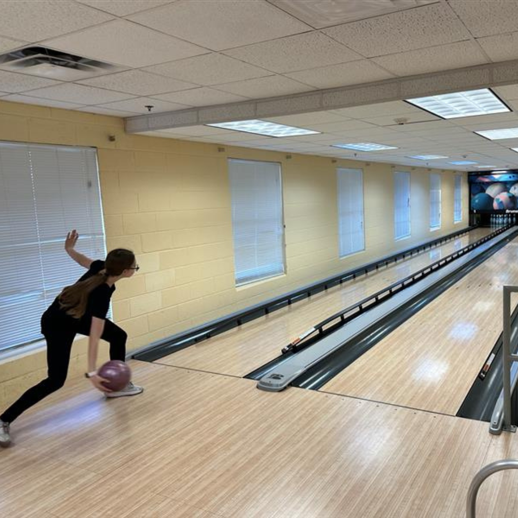A BMS student bowling inside Cobras Corner. 